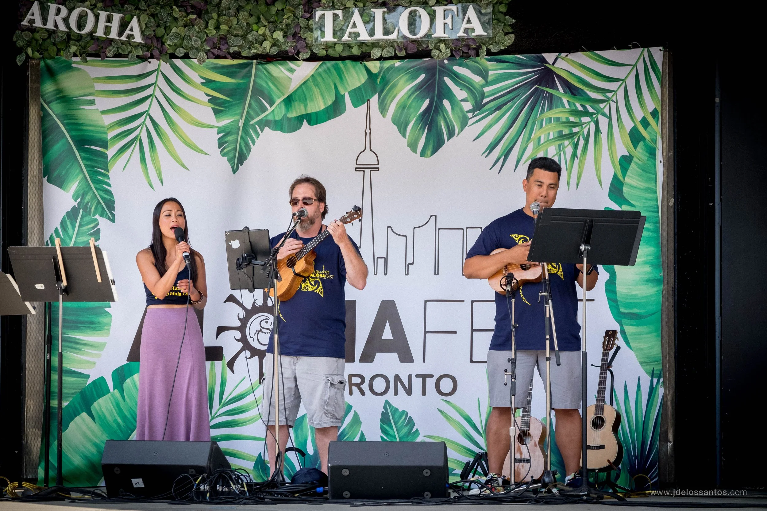 ʻUkulele players and a vocalist performing